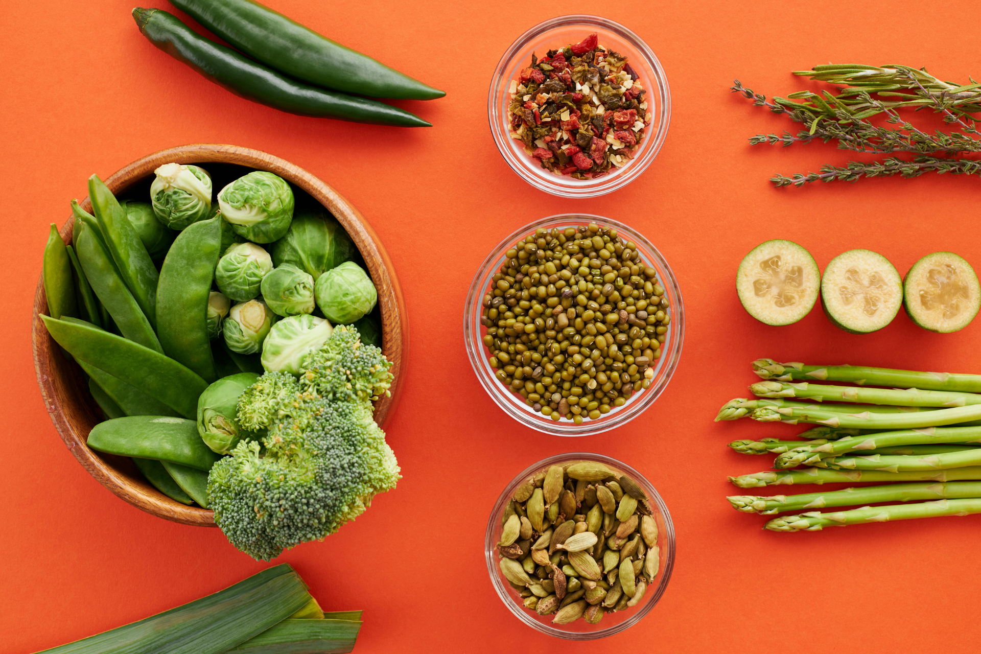 Array of healthy greens, grains, nuts, and seasonings.