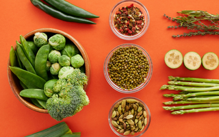 Array of healthy greens, grains, nuts, and seasonings.